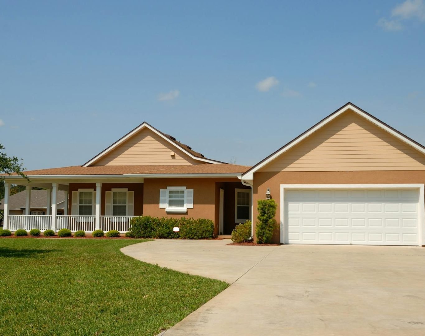 Beautiful modern suburban house with a spacious driveway and green lawn, perfect for families.