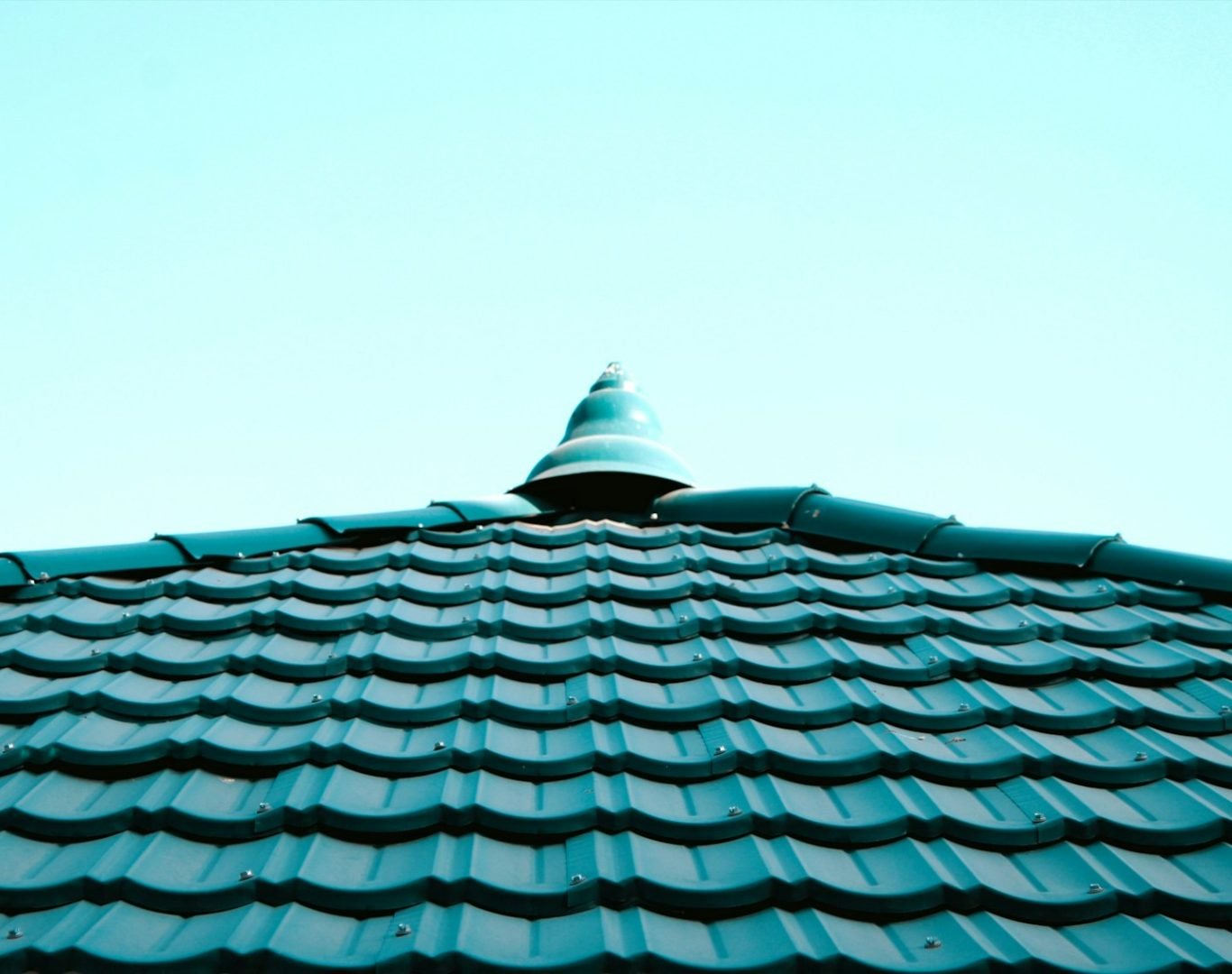 a close up of a roof with a blue sky in the background